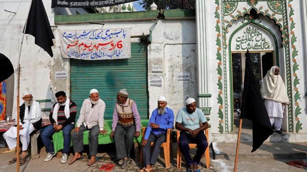 Muslims sit outside a mosque as they observe a black day marking the 25th anniversary of the razing of a 16th century Babri mosque in Ayodhya. (Reuters Photo) Muslims sit outside a mosque as they observe a black day marking the 25th anniversary of the razing of a 16th century Babri mosque in Ayodhya. (Reuters Photo)