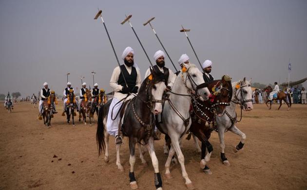 Sikhs, who now form a tiny minority of the Punjab in Pakistan, among horse-riders holding lances that are used to pick up pegs, at a tent-pegging competition during an annual festival at the village of Kot Fateh Khan in Attock district of Pakistan’s Punjab province. Festooned with garlands and colourful bridles, turbaned riders mounted on horseback in full gallop lower their lances at tiny wooden blocks as they practice the centuries-old tradition of tent-pegging. (Aamir Qureshi/AFP) Sikhs, who now form a tiny minority of the Punjab in Pakistan, among horse-riders holding lances that are used to pick up pegs, at a tent-pegging competition during an annual festival at the village of Kot Fateh Khan in Attock district of Pakistan’s Punjab province. Festooned with garlands and colourful bridles, turbaned riders mounted on horseback in full gallop lower their lances at tiny wooden blocks as they practice the centuries-old tradition of tent-pegging. (Aamir Qureshi/AFP)