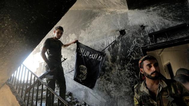 A member of the Syrian Democratic Forces calls his comrades during the battle with Islamic State fighters in Raqqa, Syria on August 14, 2017. Baghdad’s victory in July 2017 after nine months of fighting was the coup de grace for the caliphate and came three years after a jihadist juggernaut seized one third of Iraq. (Zohra Bensemra / REUTERS)
