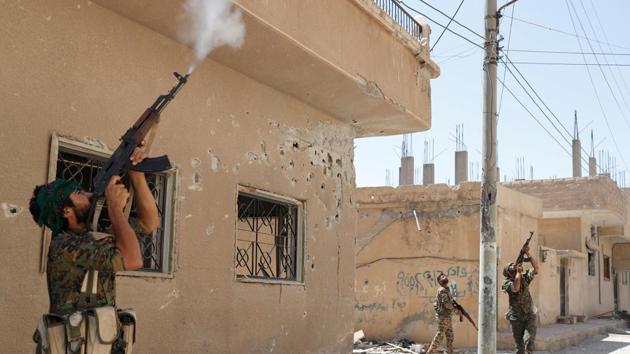 Kurdish fighters from the People’s Protection Units (YPG) fire at an ISIS drone in Raqqa, Syria in June 2017. Maliki’s successor, Haider al-Abadi, had long been seen as an ineffective leader but a US-backed campaign against IS offered him a chance to emerge as a steely statesman capable of taking on a group that had terrorised cities with beheadings in public squares while staging deadly attacks in the West. (Goran Tomasevic / REUTERS)