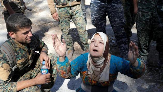A civilian prays after being rescued by Syrian Democratic Forces from the stadium after Raqqa was liberated from the Islamic in October 2017. ISIS presented themselves as saviours. But as jihadists brandishing AK-47 rifles began imposing an Islamist doctrine even more brutal and medieval than al Qaeda, their popularity soon faded. (Erik De Castro / REUTERS)