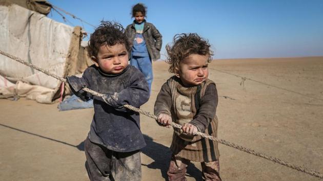 Internally displaced Syrian children who fled Raqqa stand near their tent in Ras al-Ain province, Syria. Just smoking a cigarette, an act IS saw as anti-Islamic, earned one dozens of lashes. Children were used as informers. Women in minority communities were turned into sex slaves. (Rodi Said / REUTERS)