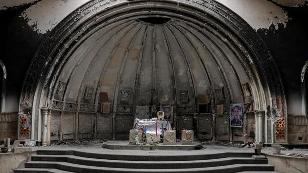 An altar of a damaged church is seen in the town of Qaraqosh, south of Mosul, in April 2017. Once home to about 50,000 mostly Iraqi Christians, it stood as ghost town. Iraqi forces kicked out ISIS fighters but citizens were still afraid to go back to their homes. The town once had 12 churches with one more than 1000 years old. Now all were destroyed or badly ruined. (Marko Djurica / REUTERS)