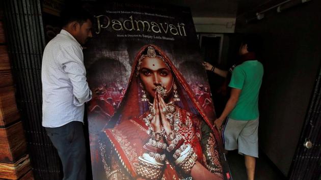 Workers carry a poster advertising Bollywood film "Padmavati" towards a ticket selling counter in a cinema hall in Kolkata on November 28.(Reuters) Workers carry a poster advertising Bollywood film "Padmavati" towards a ticket selling counter in a cinema hall in Kolkata on November 28.(Reuters)