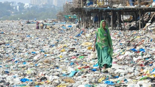 A woman walks on Versova beach, among the worst affected, where around 15,000 kg of waste has washed up.(Shashi Kashyap/HT) A woman walks on Versova beach, among the worst affected, where around 15,000 kg of waste has washed up.(Shashi Kashyap/HT)