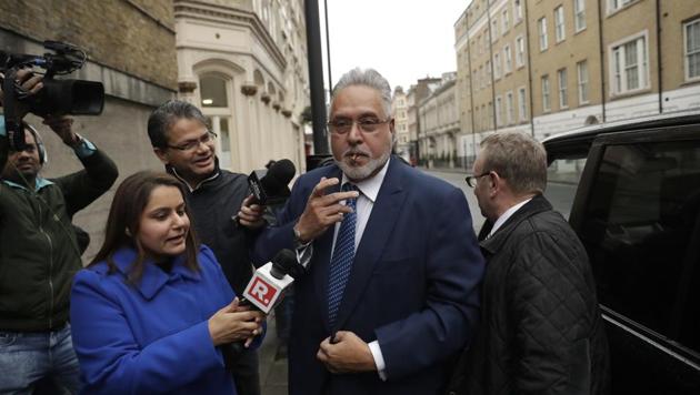 Vijay Mallya smokes as he arrives for the third day of his extradition case at Westminster Magistrates Court in London.(AP Photo)