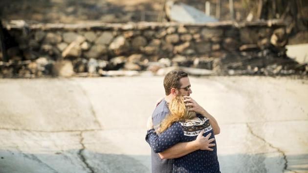 Paul and Erica Mattesich embrace before sifting through rubble at their home in Ventura. The family lost their house when the Thomas fire tore through their neighbourhood on Colina Vista. (Noah Berger / AP) Paul and Erica Mattesich embrace before sifting through rubble at their home in Ventura. The family lost their house when the Thomas fire tore through their neighbourhood on Colina Vista. (Noah Berger / AP)