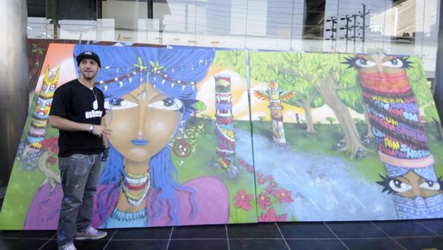 Renowned Brazilian graffiti artist Michael Devis alongside one of his works displayed at KK Modi Education Group Institute in Noida on Thursday.(Sunil Ghosh /HT Photo) Renowned Brazilian graffiti artist Michael Devis alongside one of his works displayed at KK Modi Education Group Institute in Noida on Thursday.(Sunil Ghosh /HT Photo)