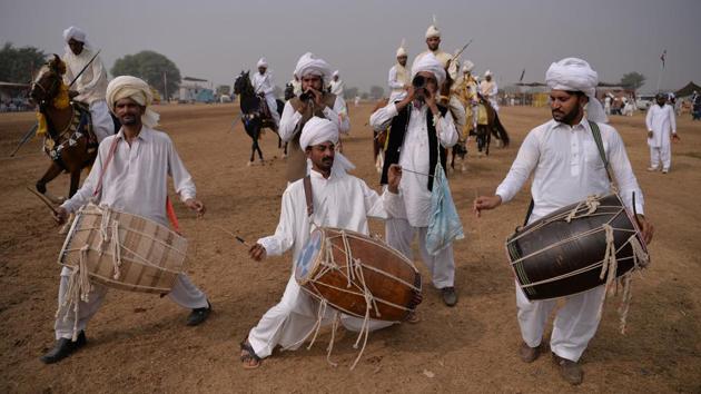 Traditional drummers perform at the tent-pegging competition at the village of Kot Fateh Khan. Less than a two-hour drive from the capital Islamabad, thousands gathered at the freshly ploughed grounds to watch the equine festival that can see riders tossed from their mounts, breaking bones or worse during the dangerous spectacle. (Aamir Qureshi / AFP) Traditional drummers perform at the tent-pegging competition at the village of Kot Fateh Khan. Less than a two-hour drive from the capital Islamabad, thousands gathered at the freshly ploughed grounds to watch the equine festival that can see riders tossed from their mounts, breaking bones or worse during the dangerous spectacle. (Aamir Qureshi / AFP)