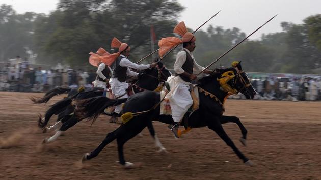 As announcers wail into microphones, riders with lances spur their steeds into a sprint toward small wooden blocks wedged in the earth, aiming to pierce the targets with their jousts. Malik Atta Muhammad Khan, a participant estimated over one thousand horses participated at this week-long festival, speaking to AFP. (Aamir Qureshi / AFP) As announcers wail into microphones, riders with lances spur their steeds into a sprint toward small wooden blocks wedged in the earth, aiming to pierce the targets with their jousts. Malik Atta Muhammad Khan, a participant estimated over one thousand horses participated at this week-long festival, speaking to AFP. (Aamir Qureshi / AFP)