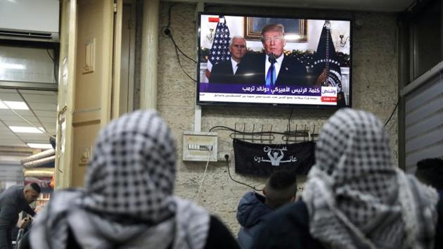 Palestinians watch a broadcast of US President Trump delivering an address where he announced that the US recognises Jerusalem as the capital of Israel. Trump said, this is “a long overdue step to advance the peace process.” Adding that the US still wanted a negotiated peace agreement — and “would support a two-state solution if agreed to by both sides”. (Ammar Awad / REUTERS) Palestinians watch a broadcast of US President Trump delivering an address where he announced that the US recognises Jerusalem as the capital of Israel. Trump said, this is “a long overdue step to advance the peace process.” Adding that the US still wanted a negotiated peace agreement — and “would support a two-state solution if agreed to by both sides”. (Ammar Awad / REUTERS)