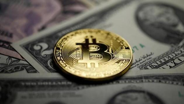 A Bitcoin and Dollar notes are seen in this illustration picture taken September 27, 2017. (Reuters File Photo) A Bitcoin and Dollar notes are seen in this illustration picture taken September 27, 2017. (Reuters File Photo)