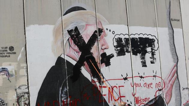 A Palestinian paints over a poster of the US President Donald Trump during a protest in Bethlehem, West Bank. (AP Photo) A Palestinian paints over a poster of the US President Donald Trump during a protest in Bethlehem, West Bank. (AP Photo)