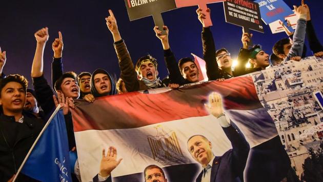 Meanwhile in Istanbul, protesters chanted slogans with posters of Turkish President Recep Tayyip Erdogan and Egypt’s former president Mohamed Morsi reading “There is no you or me, there is Jerusalem- Killer Israel get out of Palestine” during a demonstration against the US and Israel at Fatih Mosque. (Yasin Akgul / AFP) Meanwhile in Istanbul, protesters chanted slogans with posters of Turkish President Recep Tayyip Erdogan and Egypt’s former president Mohamed Morsi reading “There is no you or me, there is Jerusalem- Killer Israel get out of Palestine” during a demonstration against the US and Israel at Fatih Mosque. (Yasin Akgul / AFP)