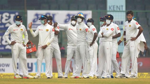 Sri Lankan players are seen wearing anti-pollution masks as they stand together to celebrate the dismissal of India's Murali Vijay during the 4th day of 3rd test match in New Delhi on Tuesday. (Atul Yadav / PTI) Sri Lankan players are seen wearing anti-pollution masks as they stand together to celebrate the dismissal of India's Murali Vijay during the 4th day of 3rd test match in New Delhi on Tuesday. (Atul Yadav / PTI)