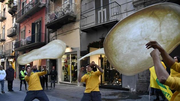 Members of the Pizzaioli Acrobats Coldiretti perform "twirling" pizza to celebrate the Unesco decision. (AFP) Members of the Pizzaioli Acrobats Coldiretti perform "twirling" pizza to celebrate the Unesco decision. (AFP)