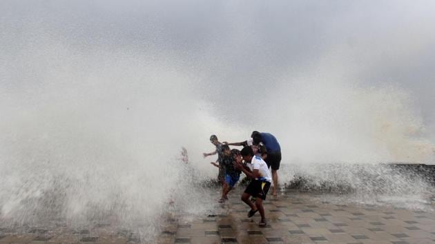 People enjoy high tide caused by Cyclone Ockhi at Worli Seaface, in Mumbai on Tuesday. (Bhushan Koyande / HT Photo) People enjoy high tide caused by Cyclone Ockhi at Worli Seaface, in Mumbai on Tuesday. (Bhushan Koyande / HT Photo)