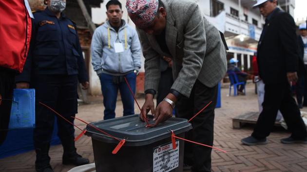 A Nepali election worker seals a ballot box after polling stations closed in Kathmandu on December 7, 2017.(AFP Photo)