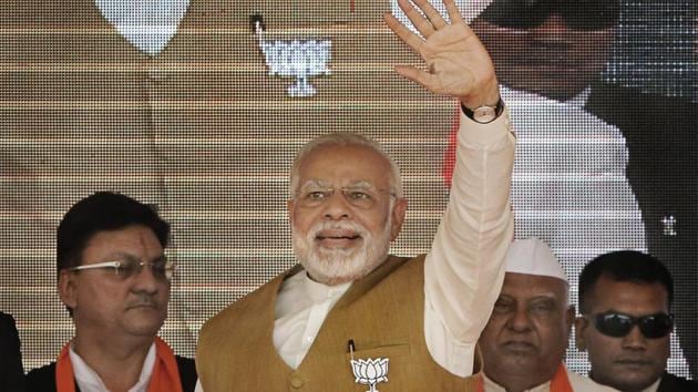 Prime Minister Narendra Modi waves to supporters during a rally for the Gujarat elections in Gandhinagar on Friday.(PTI Photo)