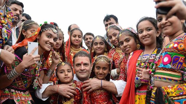 Congress Vice President Rahul Gandhi (C) poses for a photo with girls from the local area at an election campaign meeting at Anjar in Kutch district on Tuesday. (PTI) Congress Vice President Rahul Gandhi (C) poses for a photo with girls from the local area at an election campaign meeting at Anjar in Kutch district on Tuesday. (PTI)