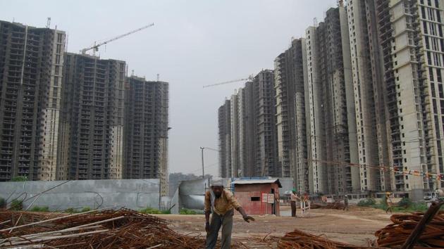 A worker working infront of DLF- Park Place (Left) and DLF Park Height (Right) in Gurgaon. July 21, 2010. Ankit Agrawal(HT File Photo) A worker working infront of DLF- Park Place (Left) and DLF Park Height (Right) in Gurgaon. July 21, 2010. Ankit Agrawal(HT File Photo)