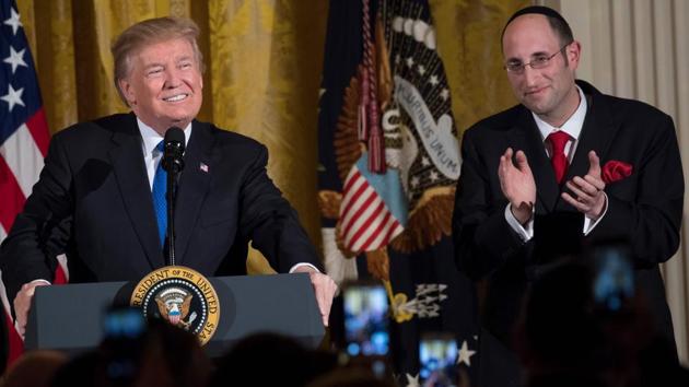 US President Donald Trump speaks alongside Rabbi Meir Soloveichik during a Hanukkah reception in the East Room of the White House in Washington on Thursday. (AFP Photo) US President Donald Trump speaks alongside Rabbi Meir Soloveichik during a Hanukkah reception in the East Room of the White House in Washington on Thursday. (AFP Photo)