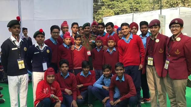 Schoolchildren from Sanghol village in Fatehgarh Sahib district and NCC cadets with Naib Subedar Sanjay Kumar, a Param Vir Chakra awardee, after an interaction at the Military Literature Festival in Chandigarh on Saturday.(Yojana Yadav/HT)