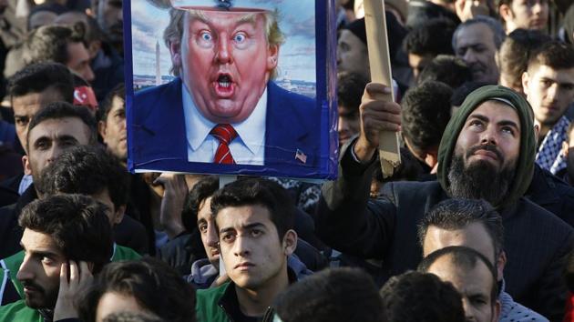 Protesters, one holding a placard with a caricature of US President Donald Trump, participate in a rally after Friday prayers in Istanbul on December 8 against his decision to recognise Jerusalem at the capital of Israel. (AP Photo) Protesters, one holding a placard with a caricature of US President Donald Trump, participate in a rally after Friday prayers in Istanbul on December 8 against his decision to recognise Jerusalem at the capital of Israel. (AP Photo)