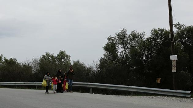 A family from Syria walks towards a makeshift camp for refugees and migrants on the island of Lesbos. Like thousands, these migrants arrived by crossing the Aegean Sea on a rubber dinghy from Turkey. According to UNHCR, in the four months to November, 15,800 asylum-seekers arrived on Greek islands -- up by 27 % from 2016. (Alkis Konstantinidis / REUTERS) A family from Syria walks towards a makeshift camp for refugees and migrants on the island of Lesbos. Like thousands, these migrants arrived by crossing the Aegean Sea on a rubber dinghy from Turkey. According to UNHCR, in the four months to November, 15,800 asylum-seekers arrived on Greek islands -- up by 27 % from 2016. (Alkis Konstantinidis / REUTERS)