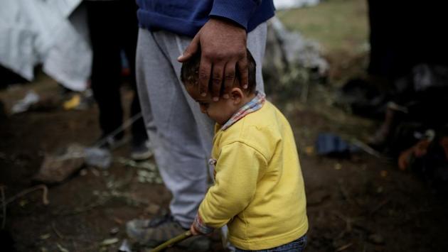 Syrian refugee Bashar Wakaa holds his son at a makeshift camp. Stranded in a muddy, garbage-strewn olive grove with no running water or toilets, Bashar is expecting the birth of his third child. He told Reuters, “If they can’t accommodate these people then why are they accepting them in the first place?” “Let them drown in the sea. At least they will die and rest”, he added. (Alkis Konstantinidis / REUTERS) Syrian refugee Bashar Wakaa holds his son at a makeshift camp. Stranded in a muddy, garbage-strewn olive grove with no running water or toilets, Bashar is expecting the birth of his third child. He told Reuters, “If they can’t accommodate these people then why are they accepting them in the first place?” “Let them drown in the sea. At least they will die and rest”, he added. (Alkis Konstantinidis / REUTERS)