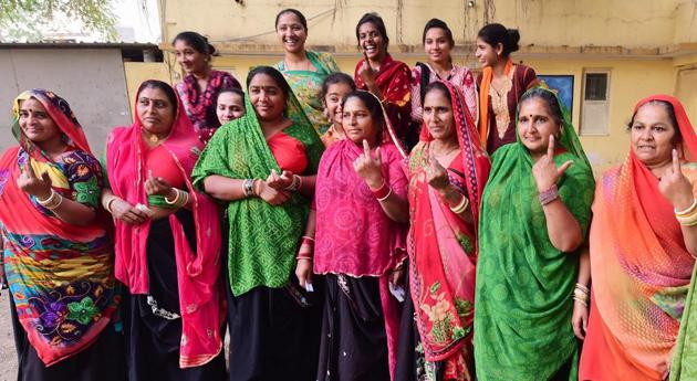 Women show their ink-marked fingers after casting their vote during the first phase of the Gujarat assembly elections, in Rajkot on Saturday.(PTI)