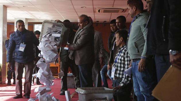 A Nepalese election commission officer empties a ballot box prior to counting the votes in Kathmandu, Nepal, Friday, Dec. 8, 2017. Election officials in Nepal on Friday began counting votes for national and provincial assemblies, the first time the Himalayan nation went to the polls to elect new federal units with the hope of bringing government closer to rural and remote areas. (AP Photo) A Nepalese election commission officer empties a ballot box prior to counting the votes in Kathmandu, Nepal, Friday, Dec. 8, 2017. Election officials in Nepal on Friday began counting votes for national and provincial assemblies, the first time the Himalayan nation went to the polls to elect new federal units with the hope of bringing government closer to rural and remote areas. (AP Photo)