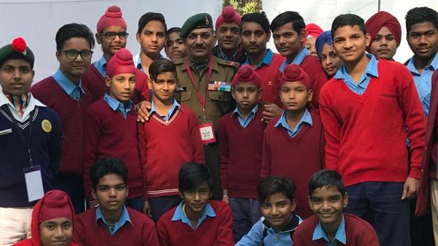 Schoolchildren from Sanghol village in Fatehgarh Sahib district and cadets with Naib Subedar Sanjay Kumar (centre), a Param Vir Chakra awardee, after an interaction at the Military Literature Festival in Chandigarh on Saturday.(Yojana Yadav/HT)