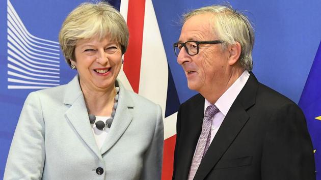 British Prime Minister Theresa May is welcomed by European Commission Jean-Claude Juncker at European Commission in Brussels on December 8, 2017. (AFP) British Prime Minister Theresa May is welcomed by European Commission Jean-Claude Juncker at European Commission in Brussels on December 8, 2017. (AFP)