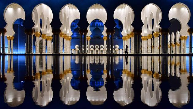 A visitor is seen walking in the courtyard of the Sheikh Zayed Grand Mosque in the UAE capital Abu Dhabi. (Giuseppe Cacase / AFP) 