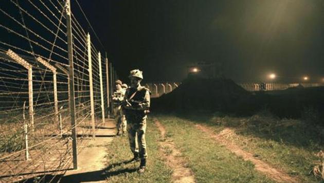 BSF soldiers standing guard during a night patrol near the fence at the India-Pakistan International Border at the outpost of Akhnoor sector, about 40 km from Jammu. (HT File Photo) BSF soldiers standing guard during a night patrol near the fence at the India-Pakistan International Border at the outpost of Akhnoor sector, about 40 km from Jammu. (HT File Photo)