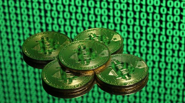 Tokens of the virtual currency Bitcoin are seen placed on a monitor that displays binary digits in this illustration picture, December 8, 2017. (REUTERS File Photo) Tokens of the virtual currency Bitcoin are seen placed on a monitor that displays binary digits in this illustration picture, December 8, 2017. (REUTERS File Photo)