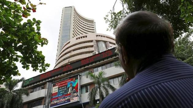 A man looks at a screen across a road displaying the Sensex on the facade of the BSE building in Mumbai, India. (Reuters File Photo) A man looks at a screen across a road displaying the Sensex on the facade of the BSE building in Mumbai, India. (Reuters File Photo)