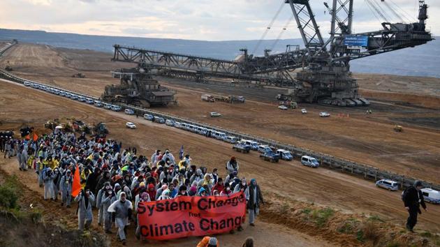 Environmentalists demonstrate at the Hambach lignite open pit mine near Elsdorf, Germany, on November 5, during a protest against fossil-based energies like coal, having negative impact on the climate change.(AFP file)