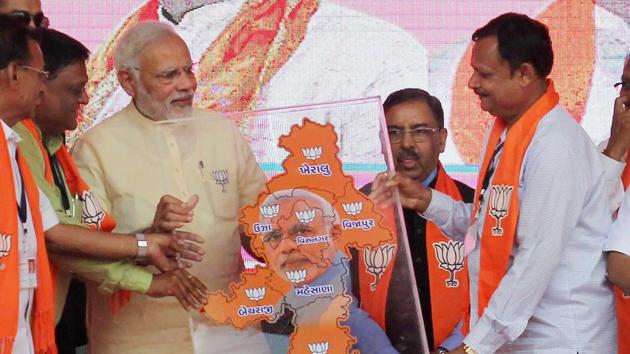 Prime Minister Narendra Modi being presented a memento during his election campaign rally for assembly election in Lunawada town of Mehsana, Gujarat on December 9. (PTI Photo) Prime Minister Narendra Modi being presented a memento during his election campaign rally for assembly election in Lunawada town of Mehsana, Gujarat on December 9. (PTI Photo)