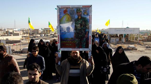 Iraqi families carry portraits of their relatives who died in the combat against the Islamic State (IS) group, at the Wadi al-Salam cemetery in the Shiite holy city of Najaf on December 10, 2017. (AFP) Iraqi families carry portraits of their relatives who died in the combat against the Islamic State (IS) group, at the Wadi al-Salam cemetery in the Shiite holy city of Najaf on December 10, 2017. (AFP)