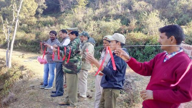 The WII team conducted a field demonstration of a European technique under which bright coloured ribbons were tied on ropes to scare the leopards away, at a village in Ekeshwar block. (HT PHOTO) The WII team conducted a field demonstration of a European technique under which bright coloured ribbons were tied on ropes to scare the leopards away, at a village in Ekeshwar block. (HT PHOTO)