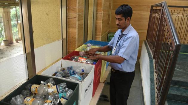 A students adds a plastic bottle to the collection box. The bottles are later sent for recycling.(Satyabtara Tripathy/HT)