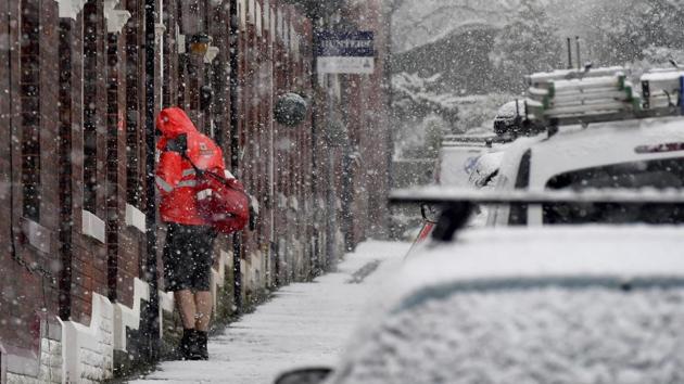 A postman delivers mail while seeming to deny the cold weather by wearing a pair of shorts, in Manchester, England. (Anthony Devlin / PA via AP) A postman delivers mail while seeming to deny the cold weather by wearing a pair of shorts, in Manchester, England. (Anthony Devlin / PA via AP)