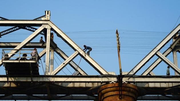 Labourers repair a railway bridge built over the Ganga river in Allahabad on December 7, 2017. (AFP) Labourers repair a railway bridge built over the Ganga river in Allahabad on December 7, 2017. (AFP)
