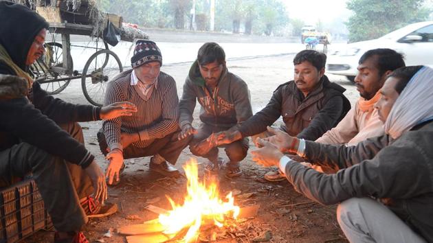 Road side vendors warm themselves in Jalandhar on Monday. (pardeep pandit/ht) Road side vendors warm themselves in Jalandhar on Monday. (pardeep pandit/ht)