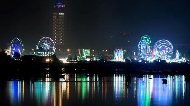 The fair lights up the night sky, as seen from Bandra Reclamation, across the creek. (Shashi S Kashyap/HT PHOTO) 