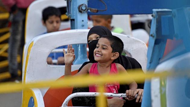 A girl and  her mother enjoy one of the many joyrides. (Shashi S Kashyap/HT PHOTO) 