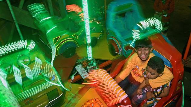 Children enjoying one of the many joyrides at the fair.  (Shashi S Kashyap/HT PHOTO) 