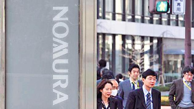 Employees outside Nomura office in Tokyo. (File Photo) Employees outside Nomura office in Tokyo. (File Photo)